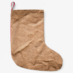 Old brown cloth background small christmas stocking