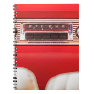Old car radio inside a red classic American car wi Notebook