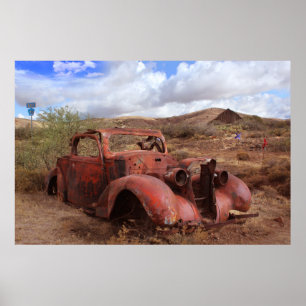 Old Car Rusting In Desert Landscape Poster