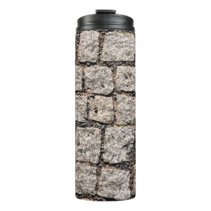 Old cobble stone pattern at the streetabstract,anc thermal tumbler