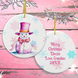 Old-Fashioned Christmas Snowman in Pink  Ceramic Tree Decoration<br><div class="desc">Pretty personalised Christmas ornament with a cute retro snowman in a pink hat surrounded by falling pink and blue snowflakes. The back can be personalised with a custom message.</div>