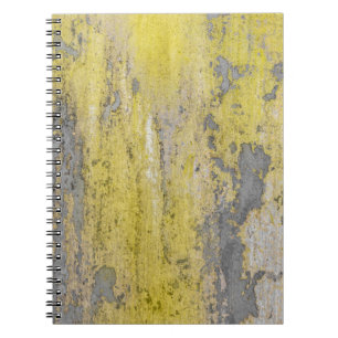 Old gray concrete wall with peeling yellow paint. notebook