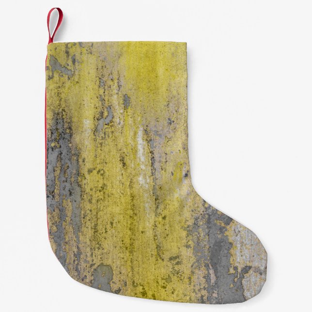 Old gray concrete wall with peeling yellow paint.  small christmas stocking (Front)