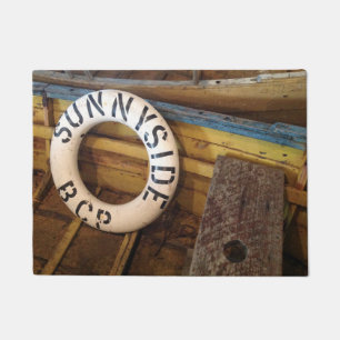 Old Life Preserver In An Abandoned Cannery Doormat