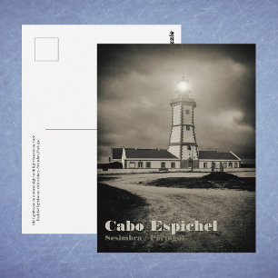 Old lighthouse on a storm night postcard