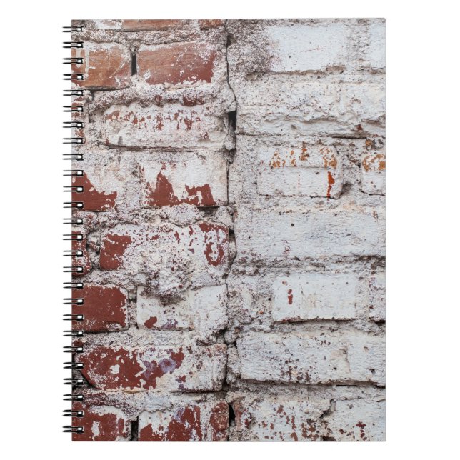 Old painted brick wall with peeling white paintwal notebook (Front)