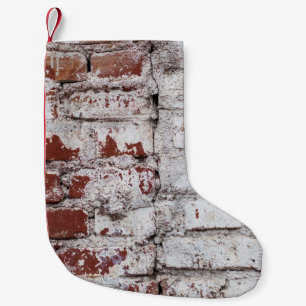 Old painted brick wall with peeling white paintwal small christmas stocking