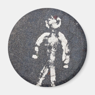 Old pedestrian symbol on a cracked road magnet