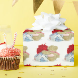 old rag doll and teddy bear hugging wrapping paper