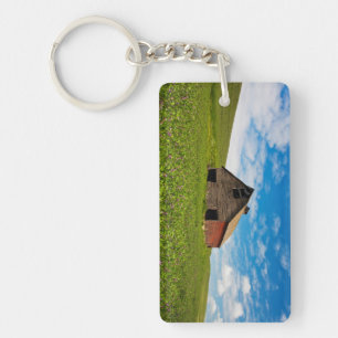 Old, red barn in field of chickpeas key ring