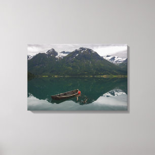 Old rowboat with mountain reflection canvas print