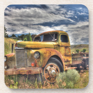 Old truck abandoned in field coaster