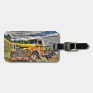 Old truck abandoned in field luggage tag