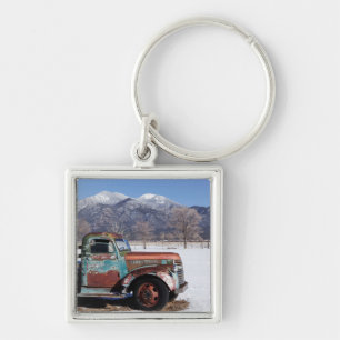 Old truck sitting in the field key ring