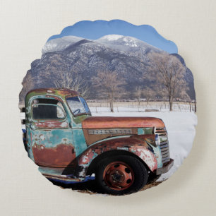 Old truck sitting in the field round cushion