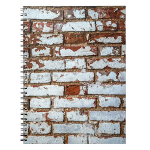 Old vintage brick wall with sprinkled white plaste notebook