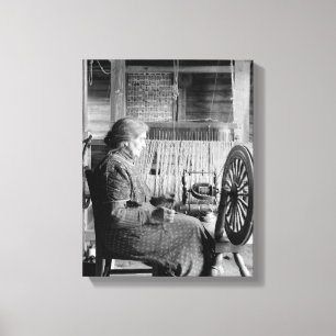 oLD wOMAN uSING sPINNING wHEEL 1930S PHOTOGRAPH Canvas Print