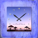 On Beach Time California Purple Pink Sunset Photo Square Wall Clock<br><div class="desc">“On beach time.” A purple blue and pink sunset on a Southern California beach with thatched palapas oozes relaxation and reflection. Relax, smell the ocean air, and recall memories of summer whenever you check the time on this chic, stylish, photography wall clock. Your choice of a round or square clock...</div>
