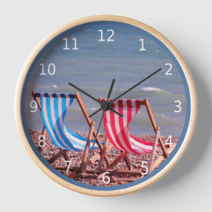 On vacation. Two deckchairs on the beach Clock