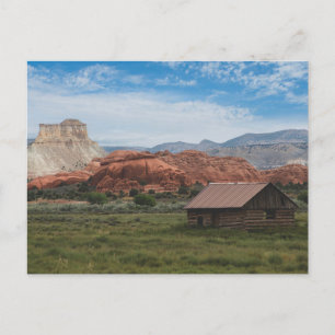 One room log cabin with sandstone hills postcard