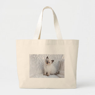 One young ragdoll cat sitting on fur in chair large tote bag