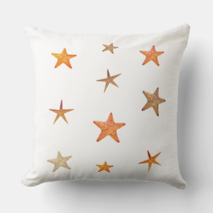 Orange and beige sea stars on white cushion