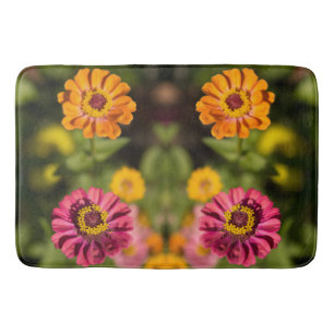 Orange and pink zinnias in blossom bath mat