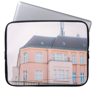 ORANGE AND WHITE CONCRETE BUILDING LAPTOP SLEEVE