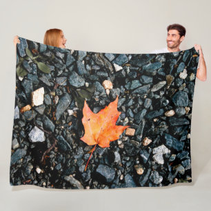 Orange Autumn Leaf on Black Rocks Fleece Blanket