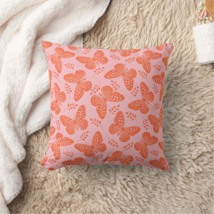 Orange butterfly pattern on pink background cushion