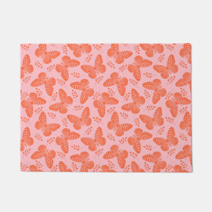 Orange butterfly pattern on pink background doormat