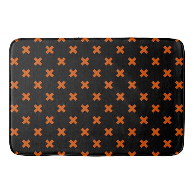 Orange cross stitches on black bath mat (Front)