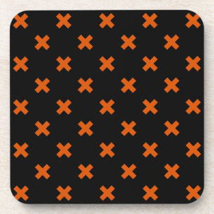 Orange cross stitches on black coaster