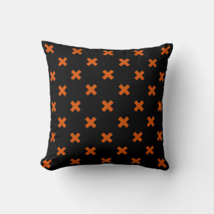 Orange cross stitches on black cushion
