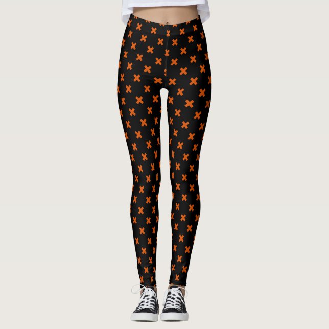 Orange cross stitches on black leggings (Front)