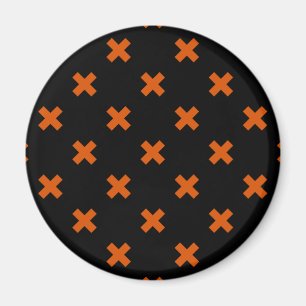 Orange cross stitches on black magnet