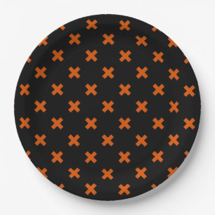Orange cross stitches on black paper plate