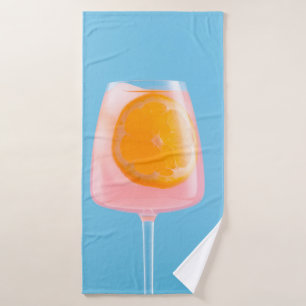 Orange juice in clear drinking glass bath towel