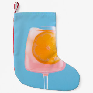 Orange juice in clear drinking glass small christmas stocking