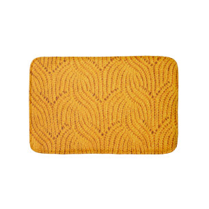 Orange knitted sweater, textured background. bath mat