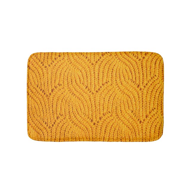 Orange knitted sweater, textured background. bath mat (Front)
