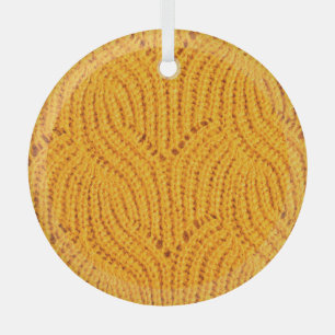 Orange knitted sweater, textured background. glass tree decoration