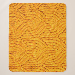 Orange knitted sweater, textured background. sherpa blanket