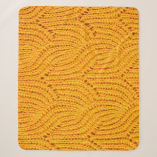Orange knitted sweater, textured background. sherpa blanket