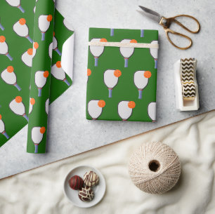 Orange Pickleballs and Paddles On Green Wrapping Paper