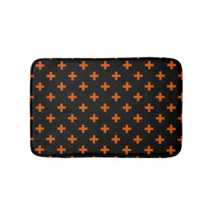 Orange polka crosses on black bath mat