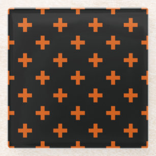 Orange polka crosses on black glass coaster