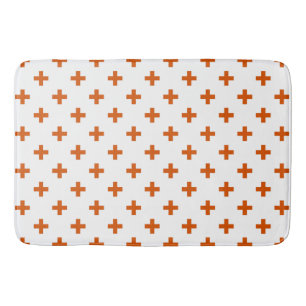 Orange polka crosses on white bath mat