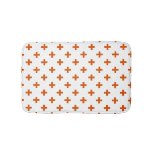 Orange polka crosses on white bath mat