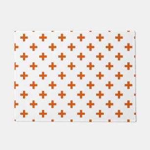 Orange polka crosses on white doormat